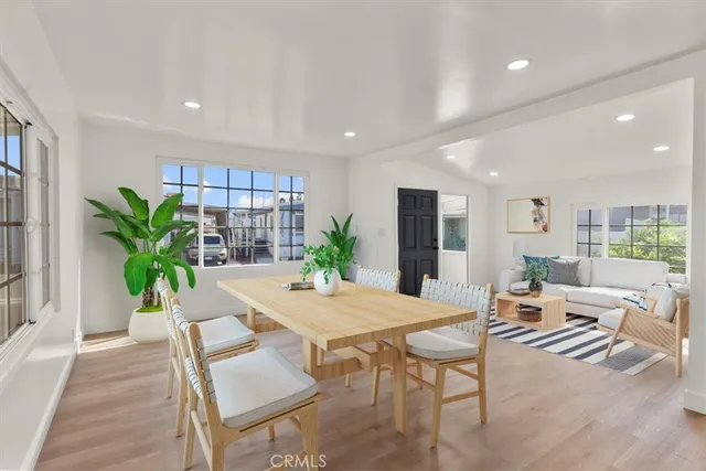 a living room with furniture potted plant and a wooden floor