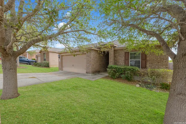 a view of a house with yard and tree s
