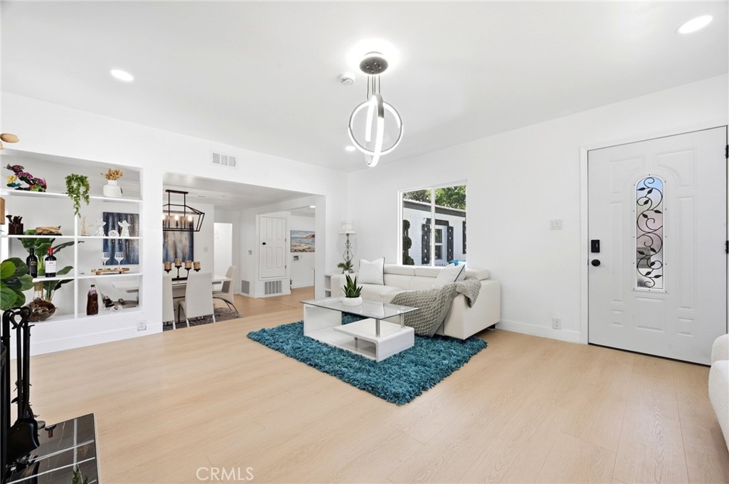 1280 East Woodbury Road Pasadena, CA 91104 - Photo 8 of 40 a living room with furniture and a chandelier