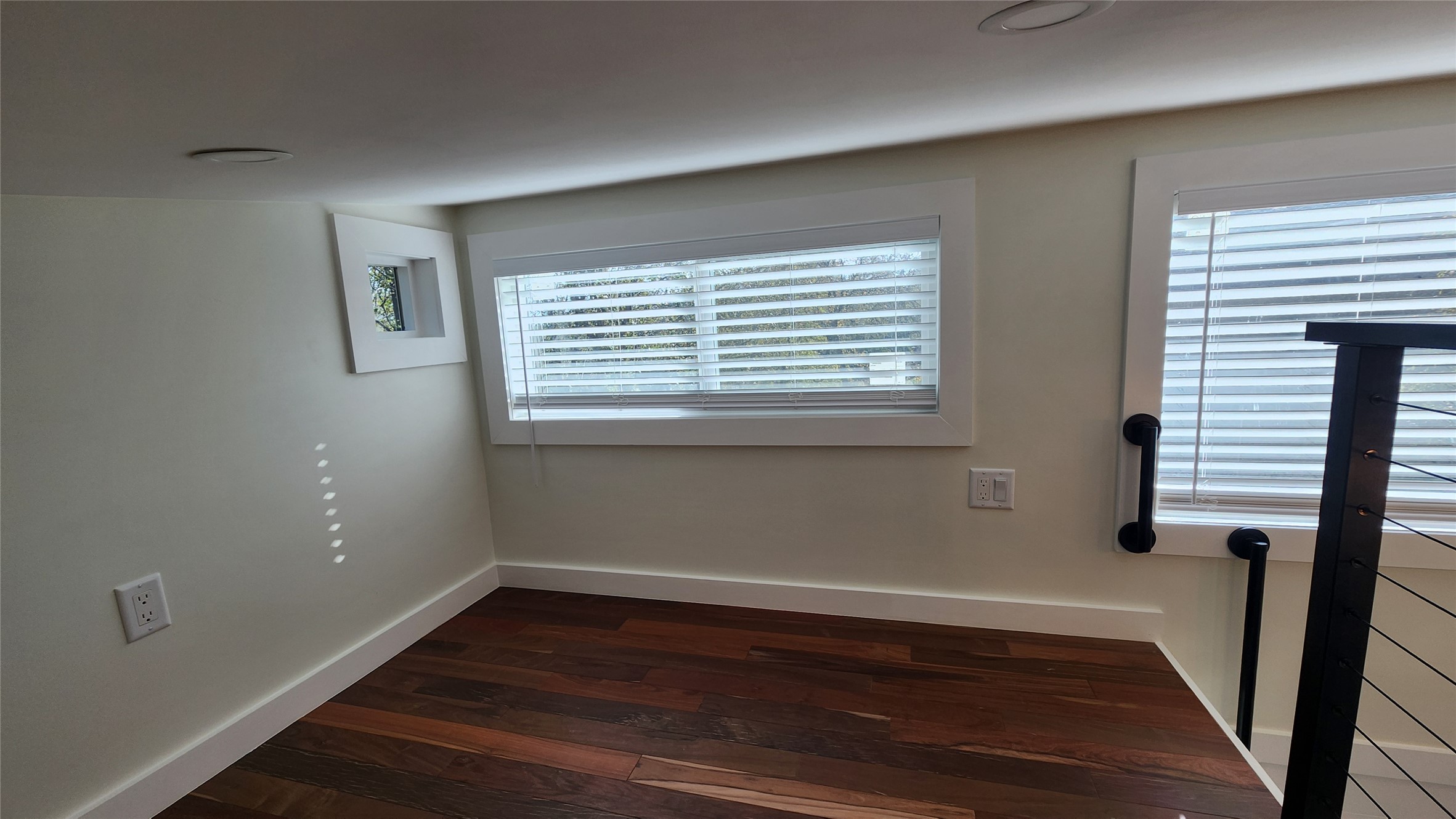 1134 Lott Avenue Austin, TX 78721 - Photo 13 of 33 a view of an empty room with wooden floor and a window