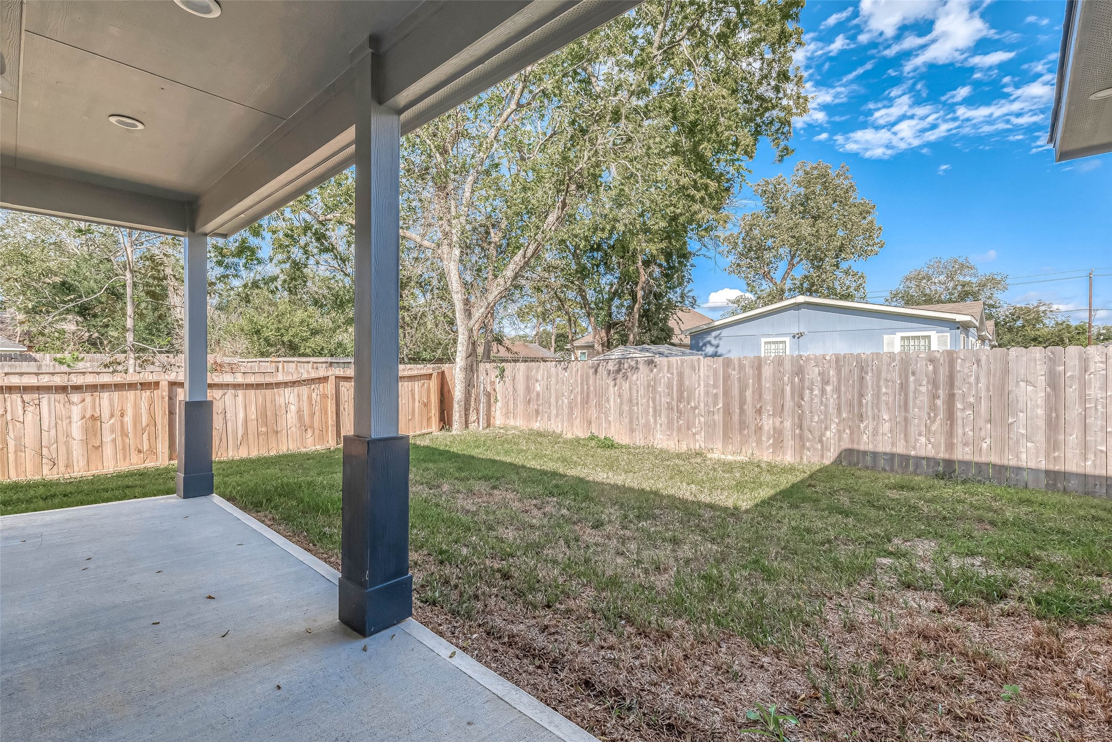 4633 Larkspur Street Houston, TX 77051 - Photo 16 of 48 a view of backyard with large trees and wooden fence