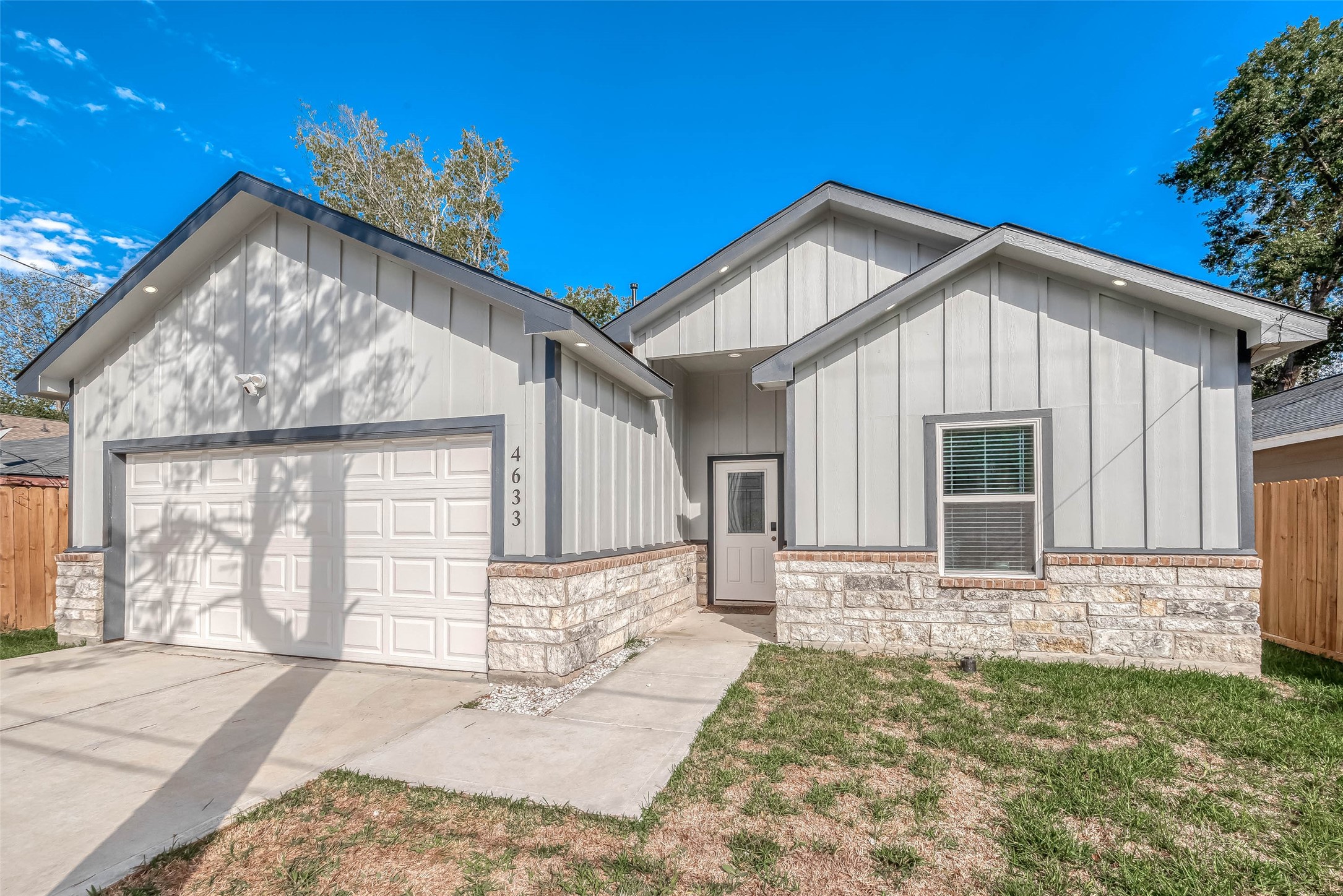 4633 Larkspur Street Houston, TX 77051 - Photo 2 of 48 a front view of a house with a yard and garage