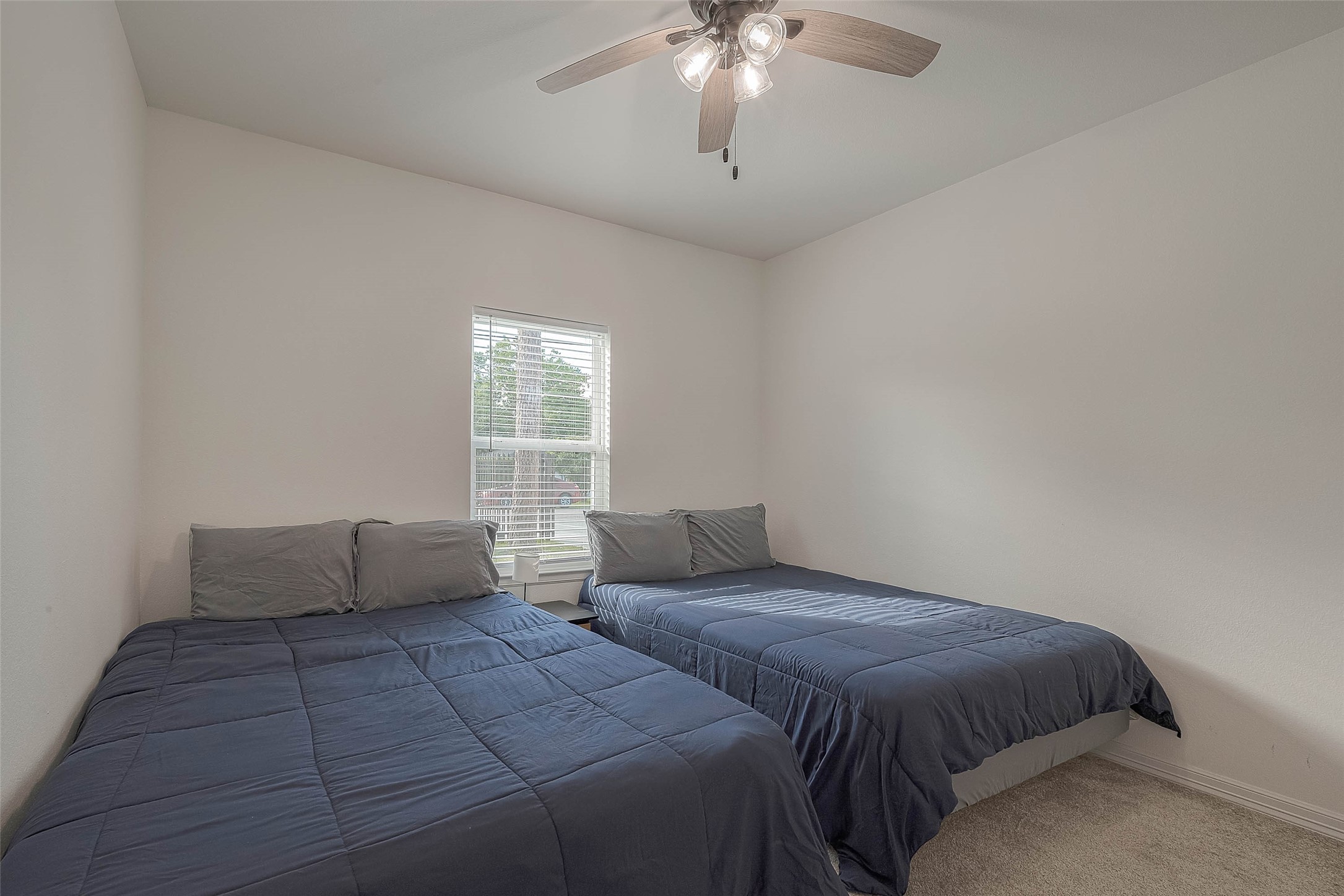 4633 Larkspur Street Houston, TX 77051 - Photo 47 of 48 a bedroom with a large bed and a window