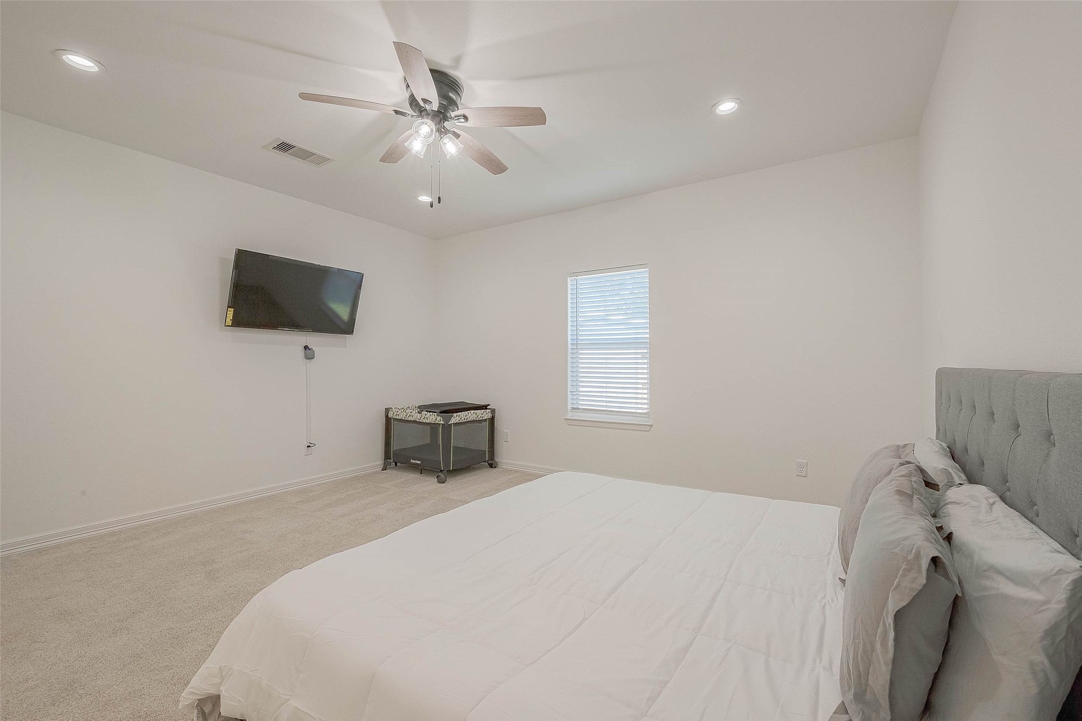 4633 Larkspur Street Houston, TX 77051 - Photo 6 of 48 a bedroom with a bed and a flat screen tv