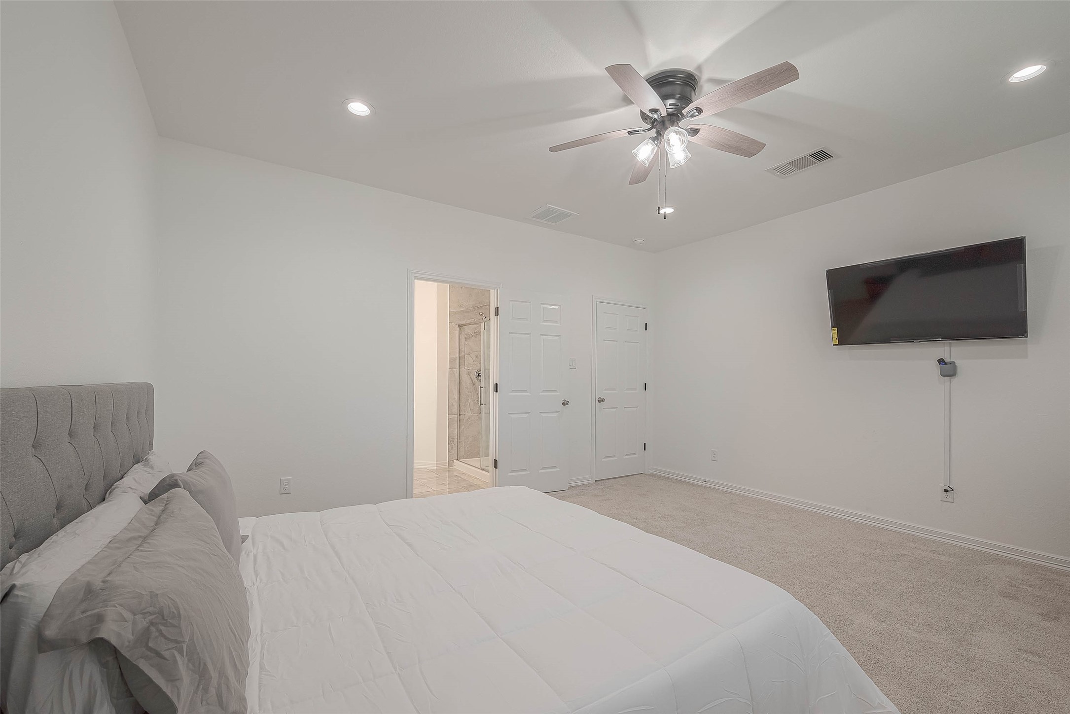 4633 Larkspur Street Houston, TX 77051 - Photo 8 of 48 a bedroom with a bed and a flat screen tv