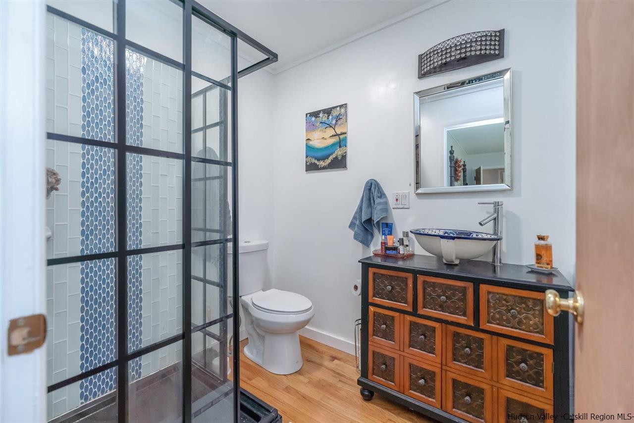 84 Benner Road Red Hook, NY 12571 - Photo 17 of 33 a bathroom with a toilet a sink and mirror