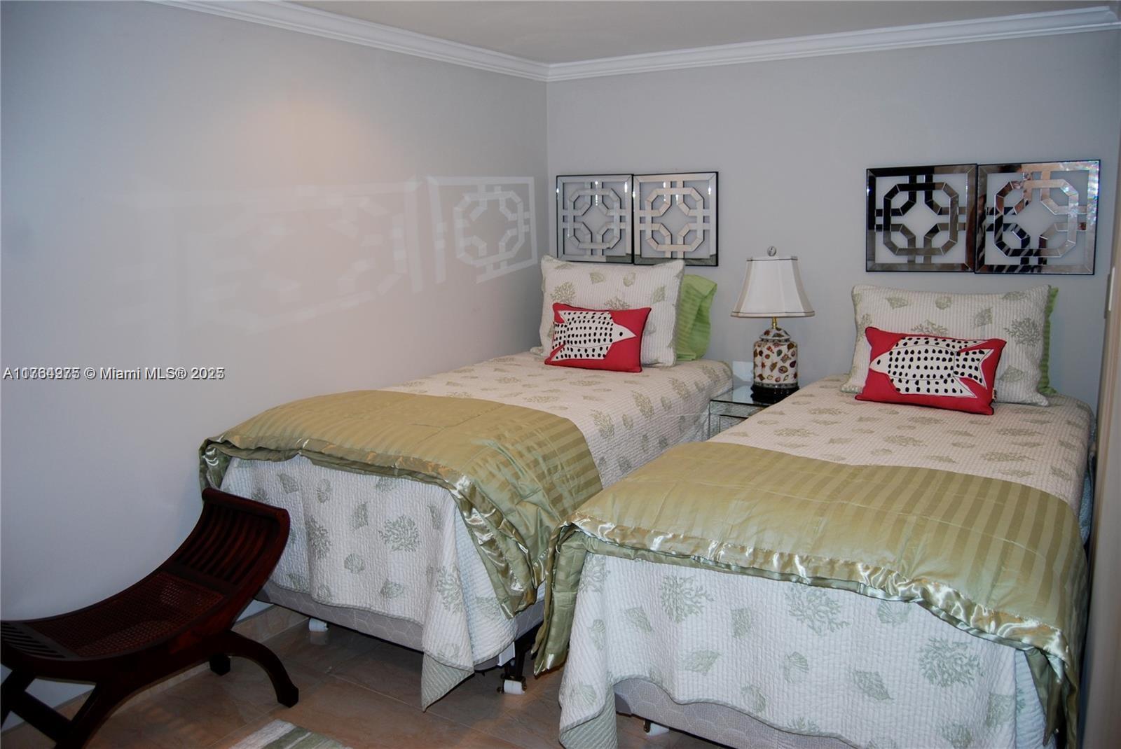 6423 Collins Avenue, Unit 901 Miami Beach, FL 33141 - Photo 14 of 17 a bedroom with a bed a table and chair