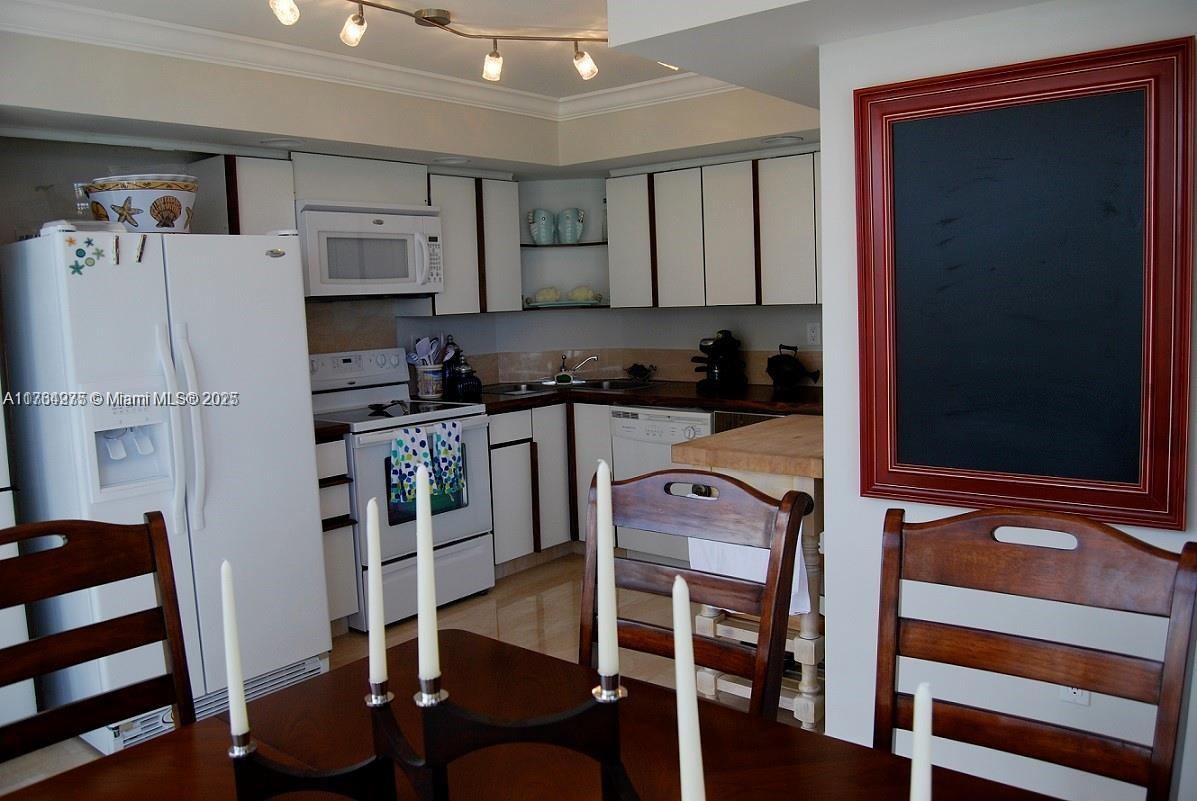 6423 Collins Avenue, Unit 901 Miami Beach, FL 33141 - Photo 7 of 17 a kitchen with stainless steel appliances granite countertop a refrigerator and a stove top oven