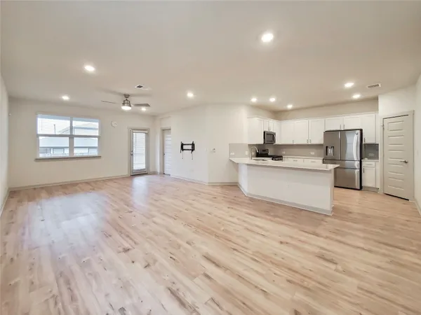 a view of kitchen with wooden floor and window