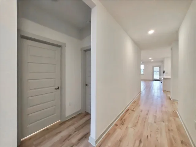a view of hallway with wooden floor