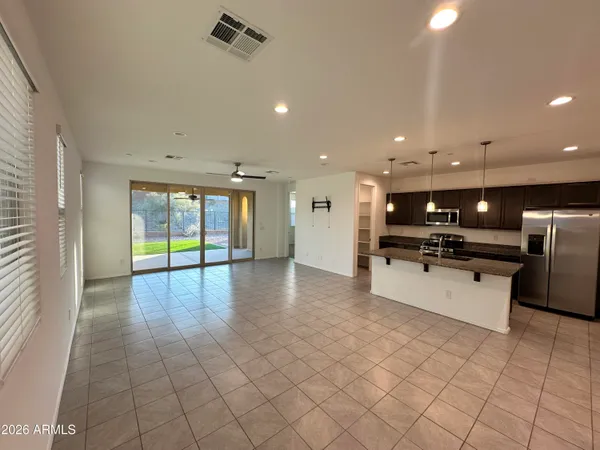 a view of kitchen with furniture and refrigerator