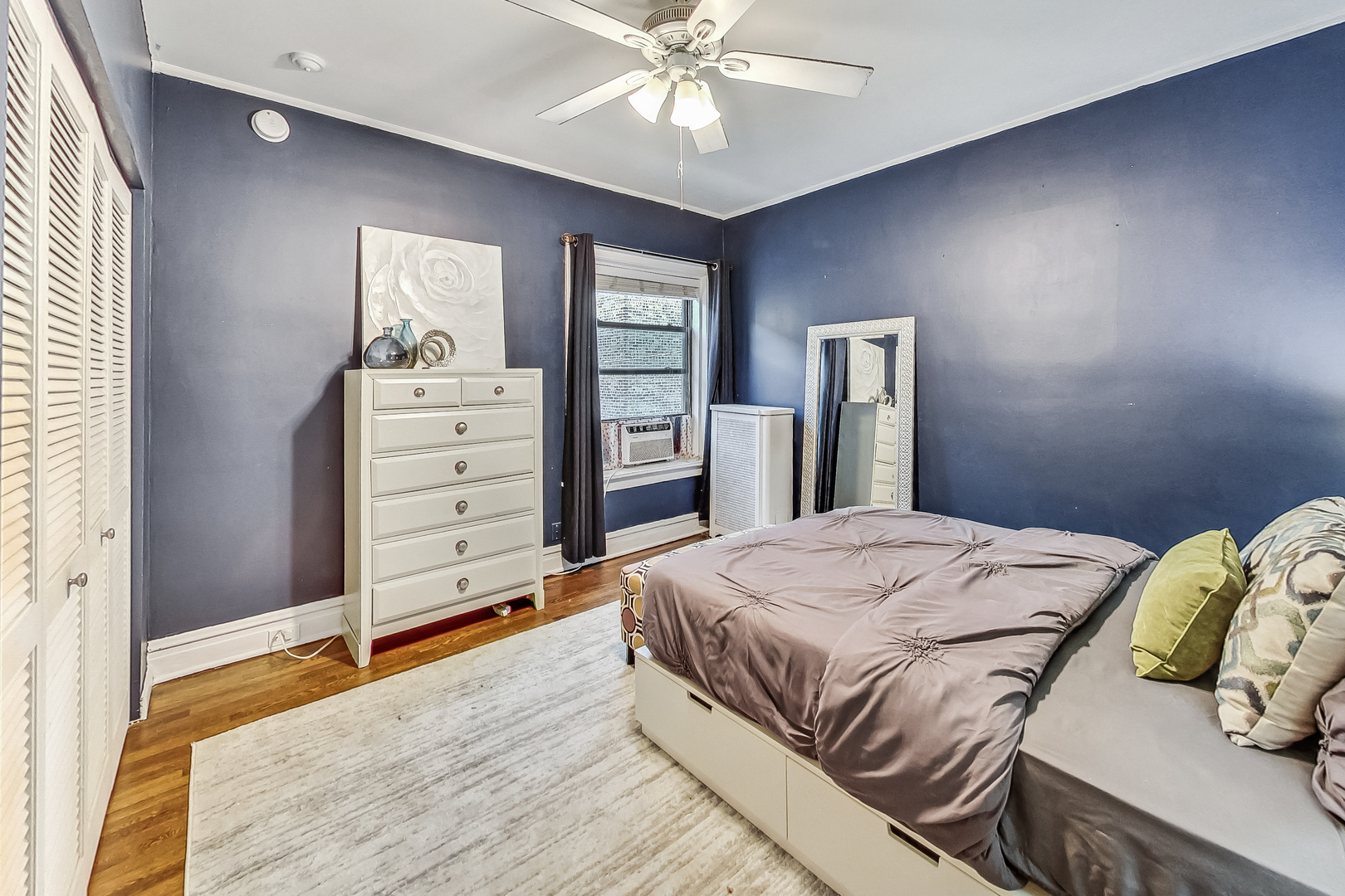 545 West Brompton Avenue, Unit 2S Chicago, IL 60657 - Photo 16 of 29 a bedroom with a bed and a chandelier