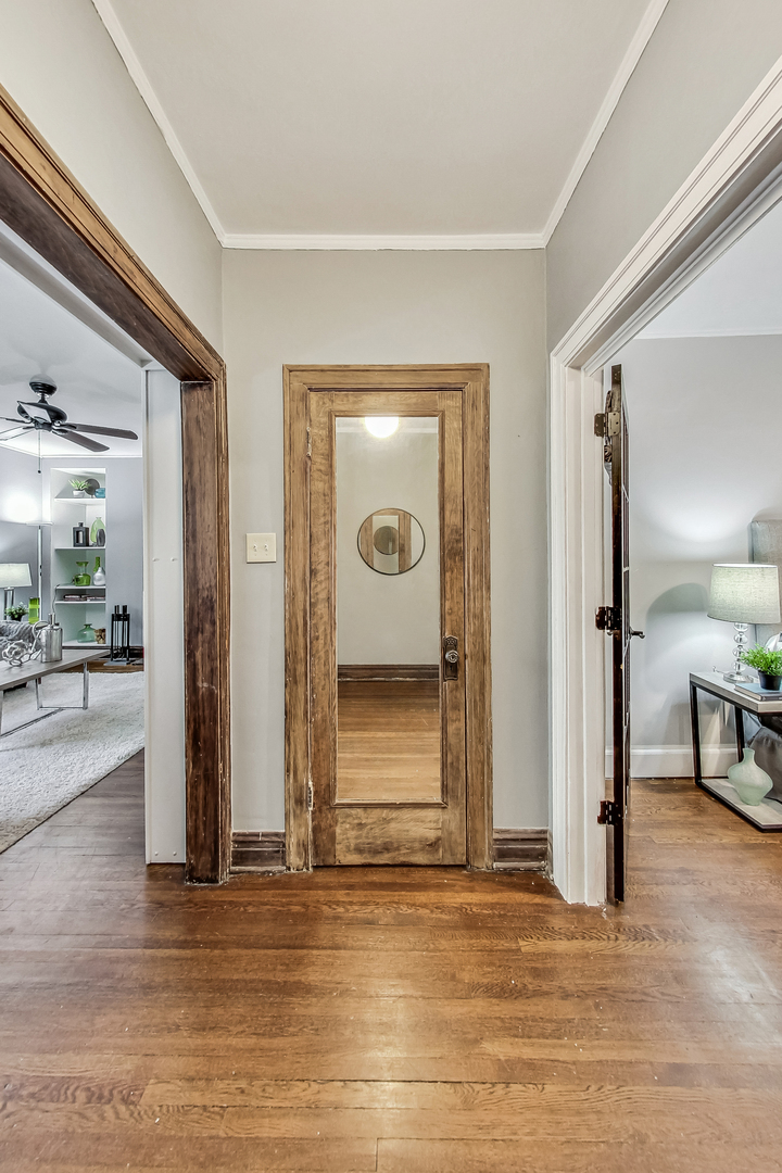 545 West Brompton Avenue, Unit 2S Chicago, IL 60657 - Photo 5 of 29 a view of a hallway with wooden floor and a fireplace