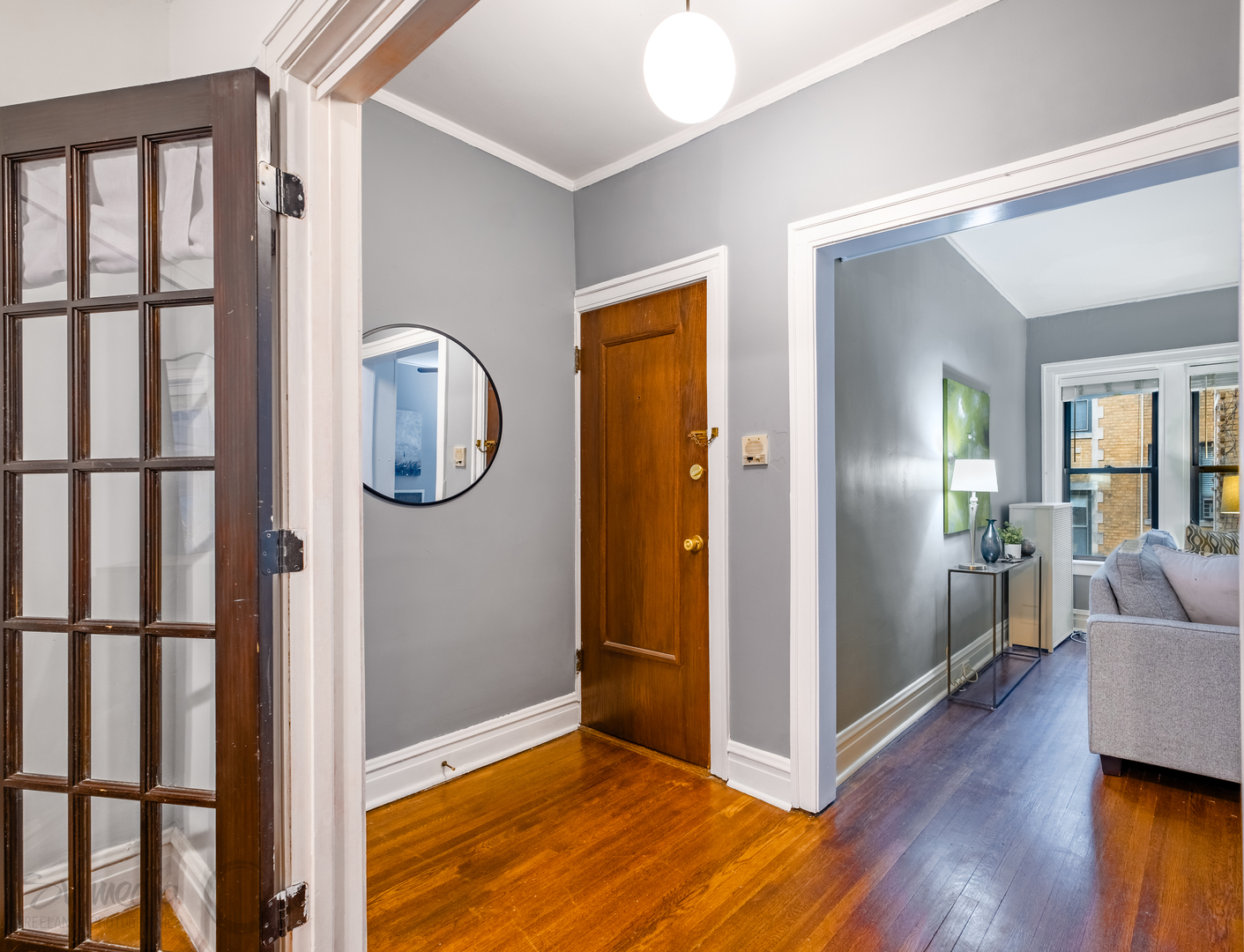 545 West Brompton Avenue, Unit 2S Chicago, IL 60657 - Photo 6 of 29 a view of a hallway with wooden floor and a cabinet