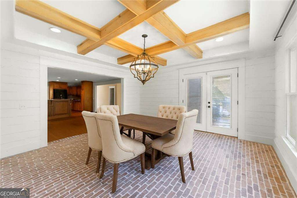 749 Hubert Pittman Road, Unit TRACT 2 Pendergrass, GA 30567 - Photo 11 of 61 a dining room with furniture a chandelier and wooden floor