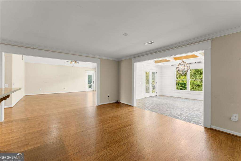 749 Hubert Pittman Road, Unit TRACT 2 Pendergrass, GA 30567 - Photo 17 of 61 a view of an empty room with wooden floor and a window