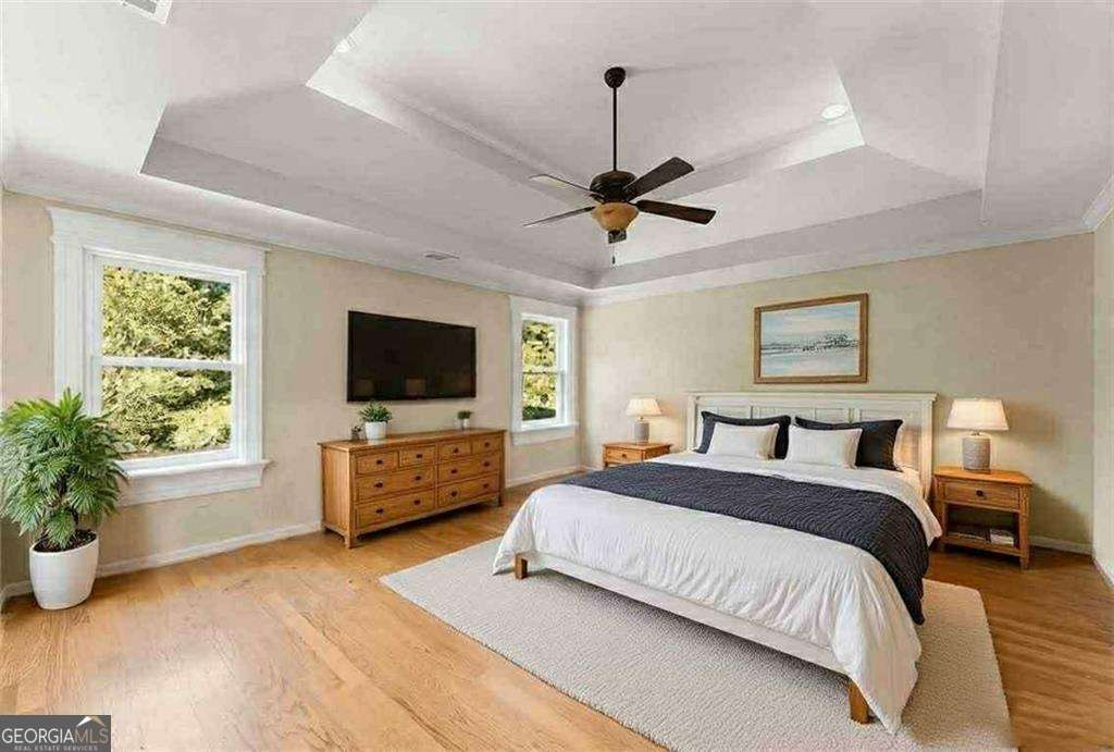 749 Hubert Pittman Road, Unit TRACT 2 Pendergrass, GA 30567 - Photo 19 of 61 a spacious bedroom with a bed and a flat screen tv