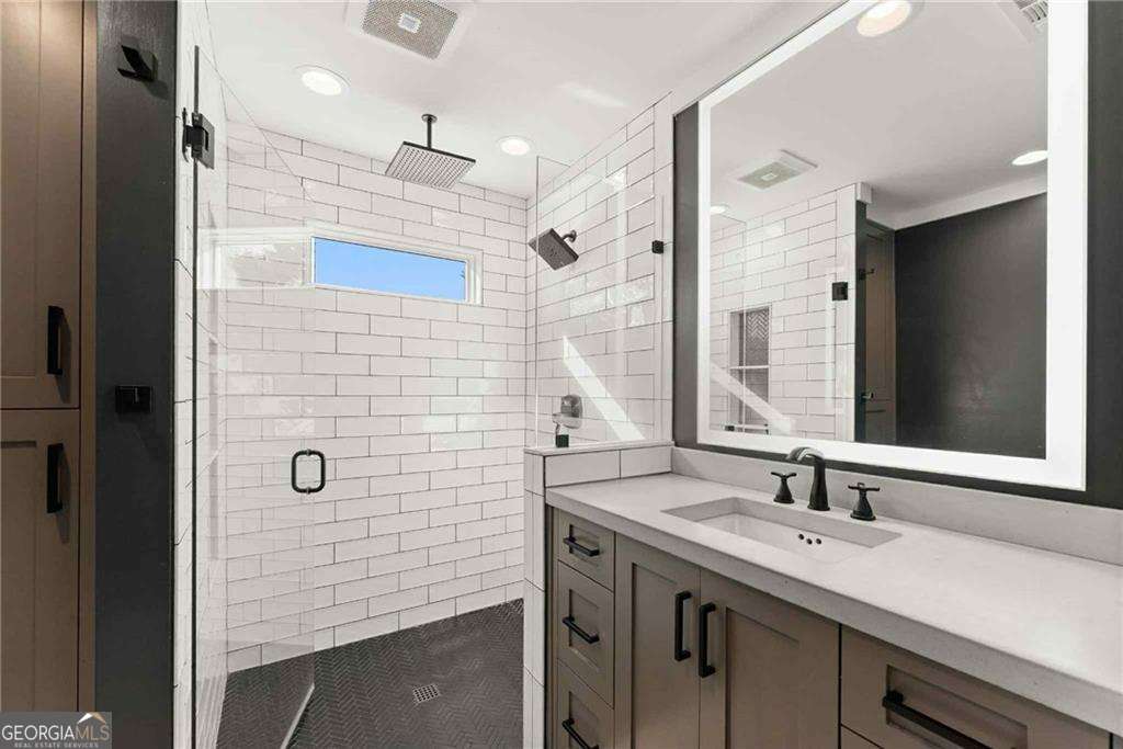 749 Hubert Pittman Road, Unit TRACT 2 Pendergrass, GA 30567 - Photo 20 of 61 a bathroom with a sink shower and a mirror