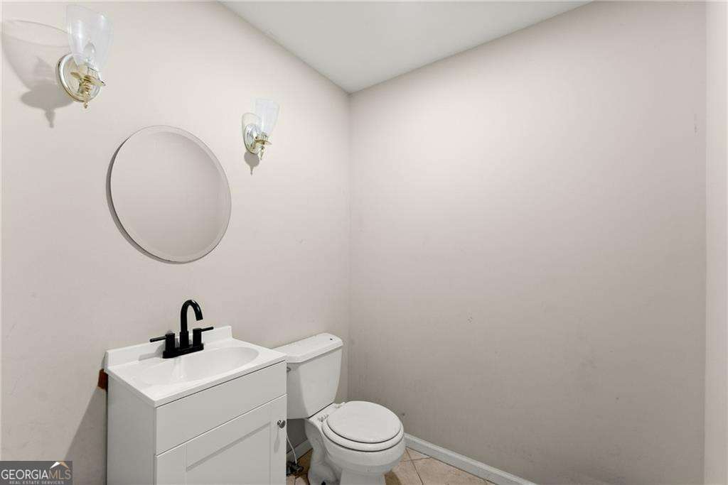 749 Hubert Pittman Road, Unit TRACT 2 Pendergrass, GA 30567 - Photo 29 of 61 a bathroom with a toilet a sink and a mirror