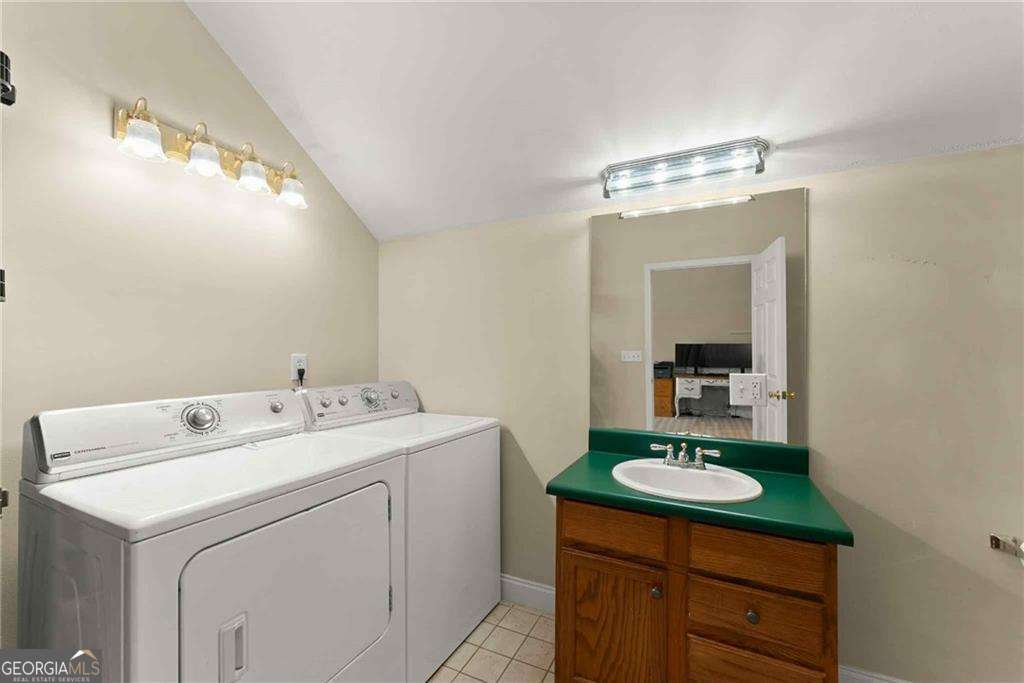 749 Hubert Pittman Road, Unit TRACT 2 Pendergrass, GA 30567 - Photo 51 of 61 a bathroom with a sink a toilet and mirror