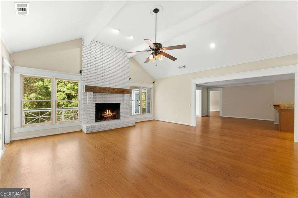 749 Hubert Pittman Road, Unit TRACT 2 Pendergrass, GA 30567 - Photo 8 of 61 a view of an empty room with wooden floor fireplace and a window