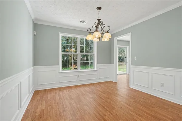 a view of livingroom with chandelier and wooden floor