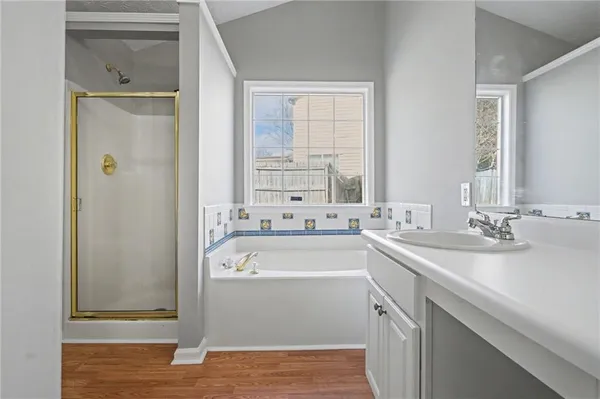 a bathroom with a sink a mirror and a bathtub