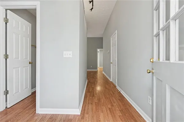 a view of a hallway with wooden floor