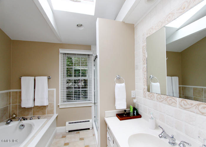 21 Pierce Road Riverside, CT 06878 - Photo 10 of 16 a bathroom with a bathtub sink and a mirror