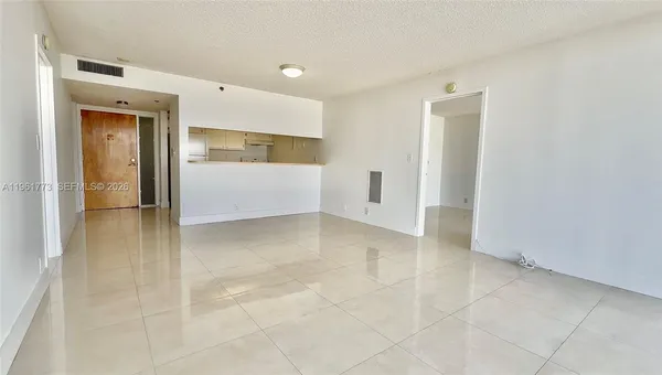 a kitchen with cabinets and a refrigerator