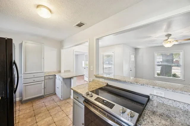 a kitchen with a stove a sink and a refrigerator