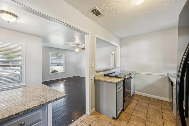 a kitchen with a stove and a refrigerator