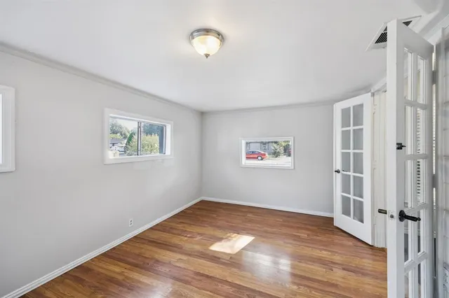a view of a room with wooden floor and window