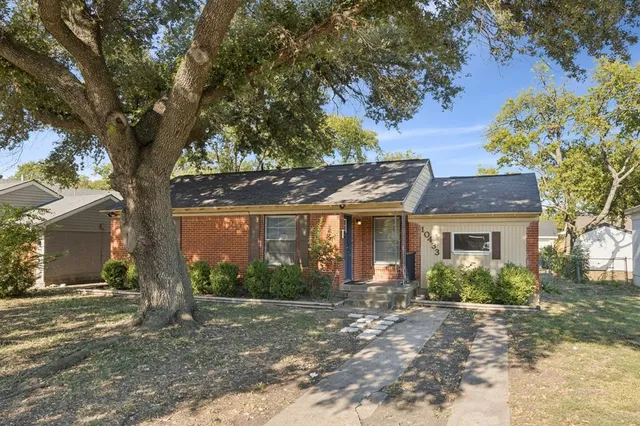 front view of a house with a tree in front of it