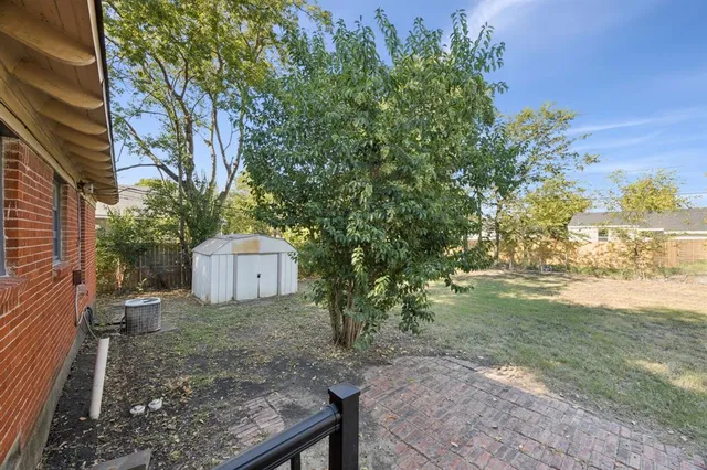 a view of a backyard with a tree