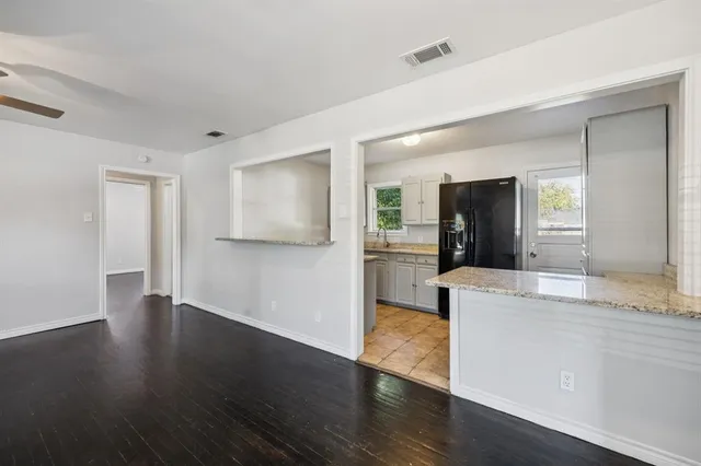 a view of a kitchen cabinets and wooden floor