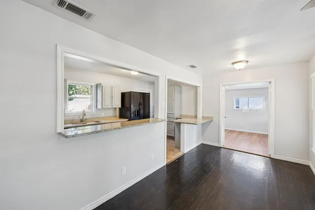 a view of a living room with furniture and flat screen tv
