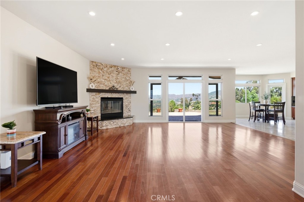 1186 Lydia Lane Fallbrook, CA 92028 - Photo 17 of 68 a living room with fireplace furniture and a flat screen tv