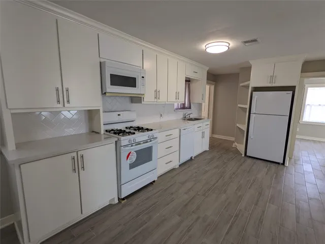 a kitchen with stainless steel appliances a stove a sink and a refrigerator