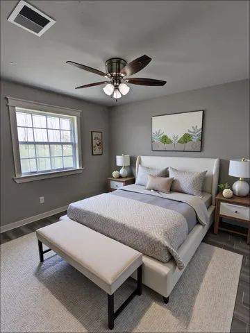 a spacious bedroom with a bed and a chandelier