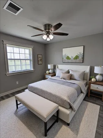 a spacious bedroom with a bed and a chandelier
