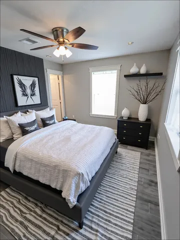 a bedroom with double bed and a chandelier