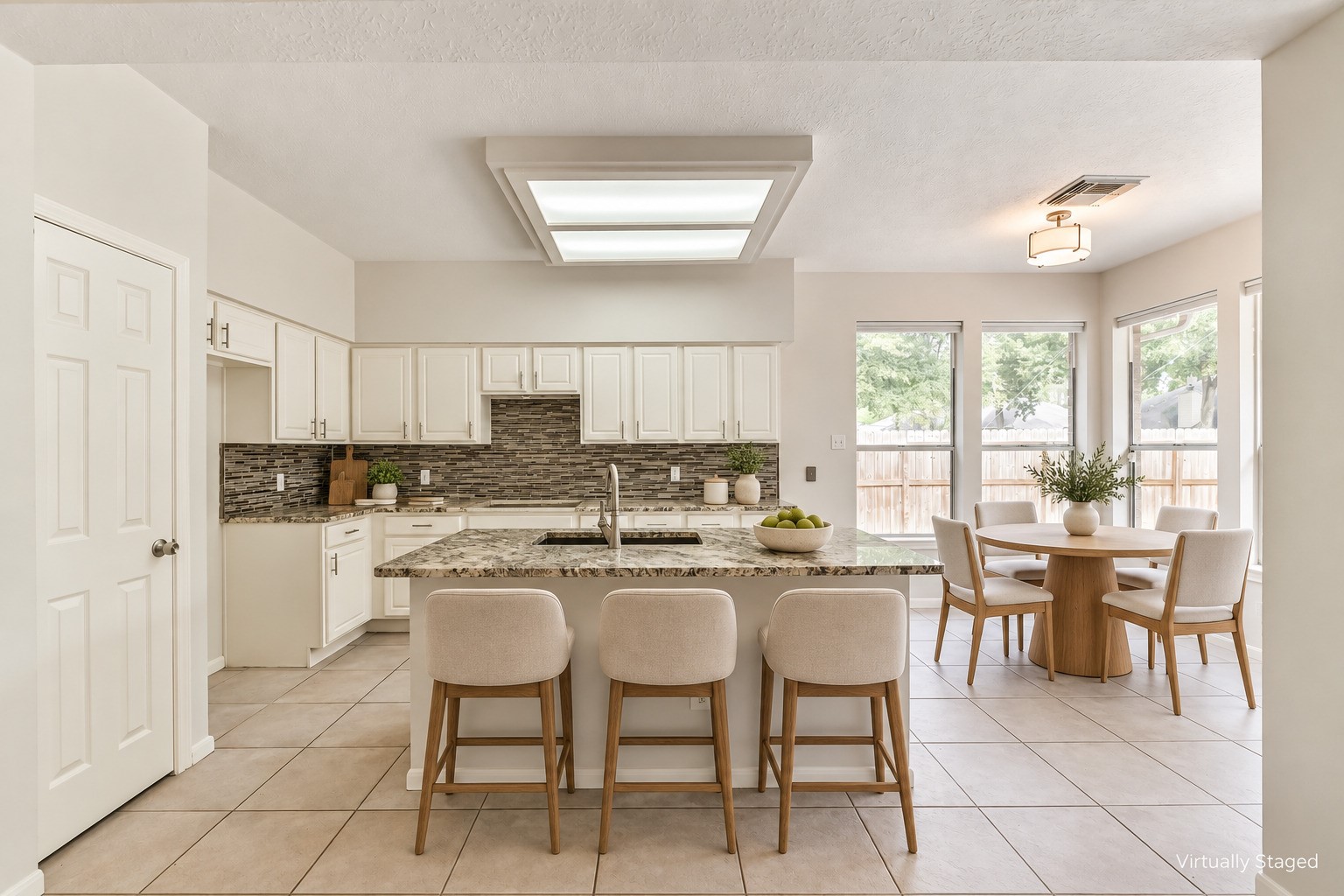 6338 Maple Spring Place Humble, TX 77346 - Photo 6 of 50 Virtually staged — From a quick bite at the island to a leisurely meal by the windows, this kitchen offers inviting places to connect throughout the day, with ample counter space for preparing and serving meals.