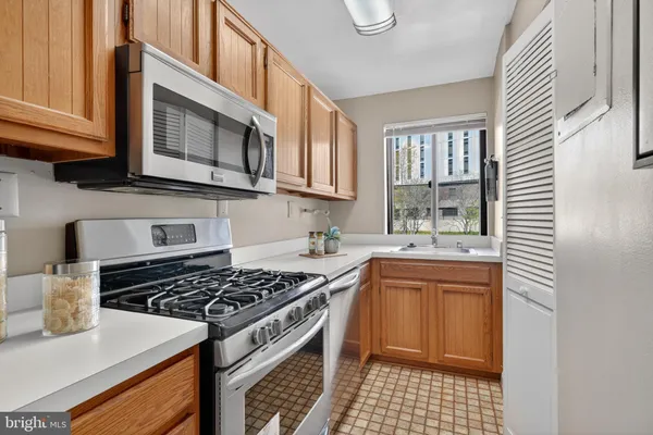 a kitchen with stainless steel appliances granite countertop a stove and a sink