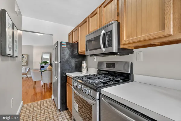 a kitchen with stainless steel appliances granite countertop a stove and a refrigerator