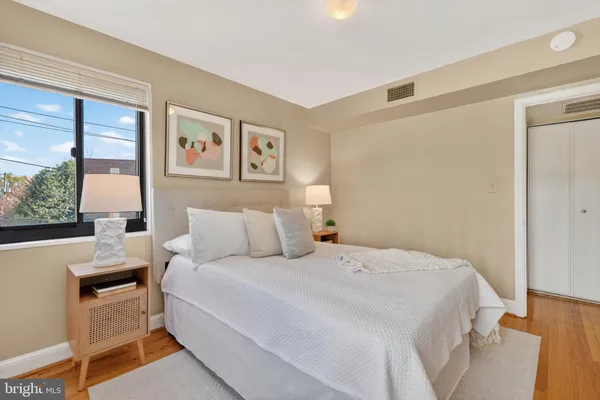 a bed room with a bed and a painting on the wall