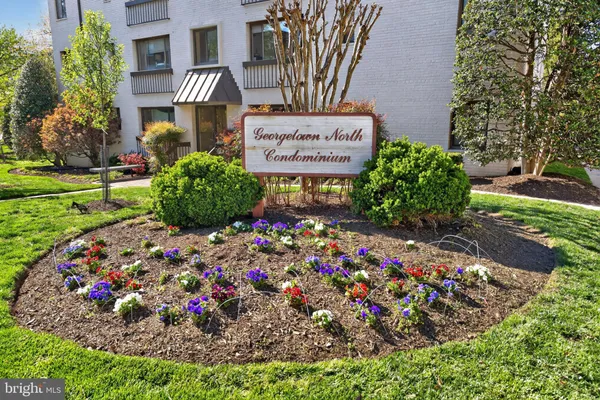 a sign that is in front of flowers