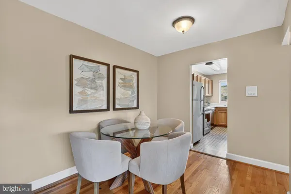 a dining room with furniture and wooden floor