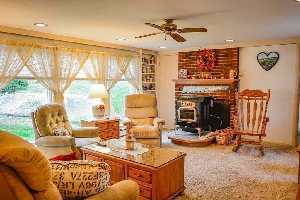 345 Richardson Road Ashby, MA 01431 - Photo 17 of 37 a living room with furniture a fireplace and a large window