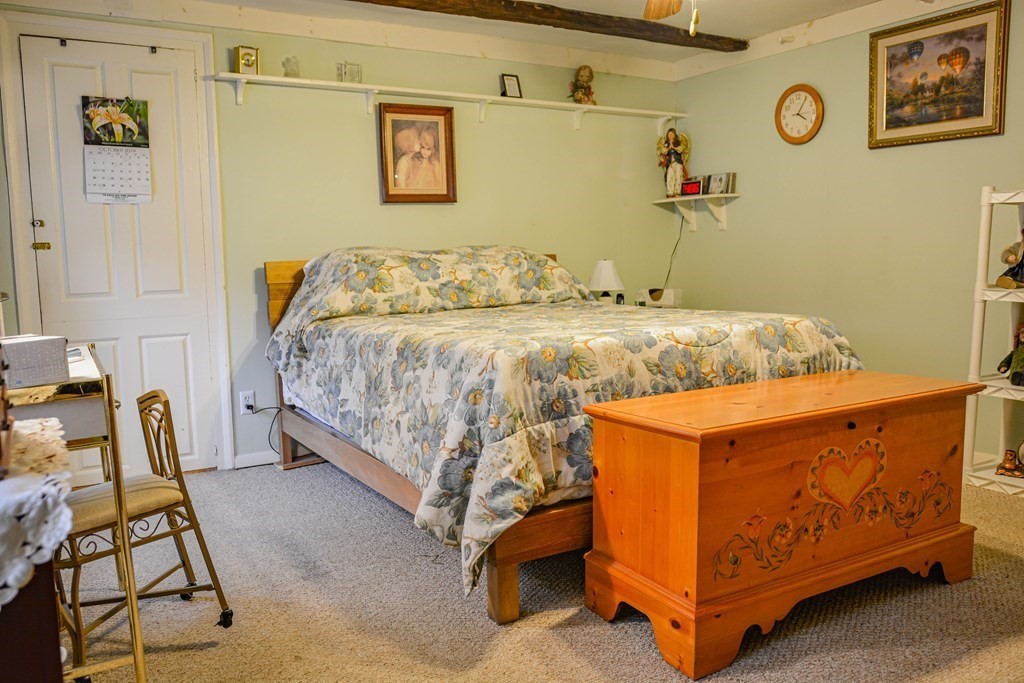 345 Richardson Road Ashby, MA 01431 - Photo 19 of 37 a bed sitting in a bedroom next to a window